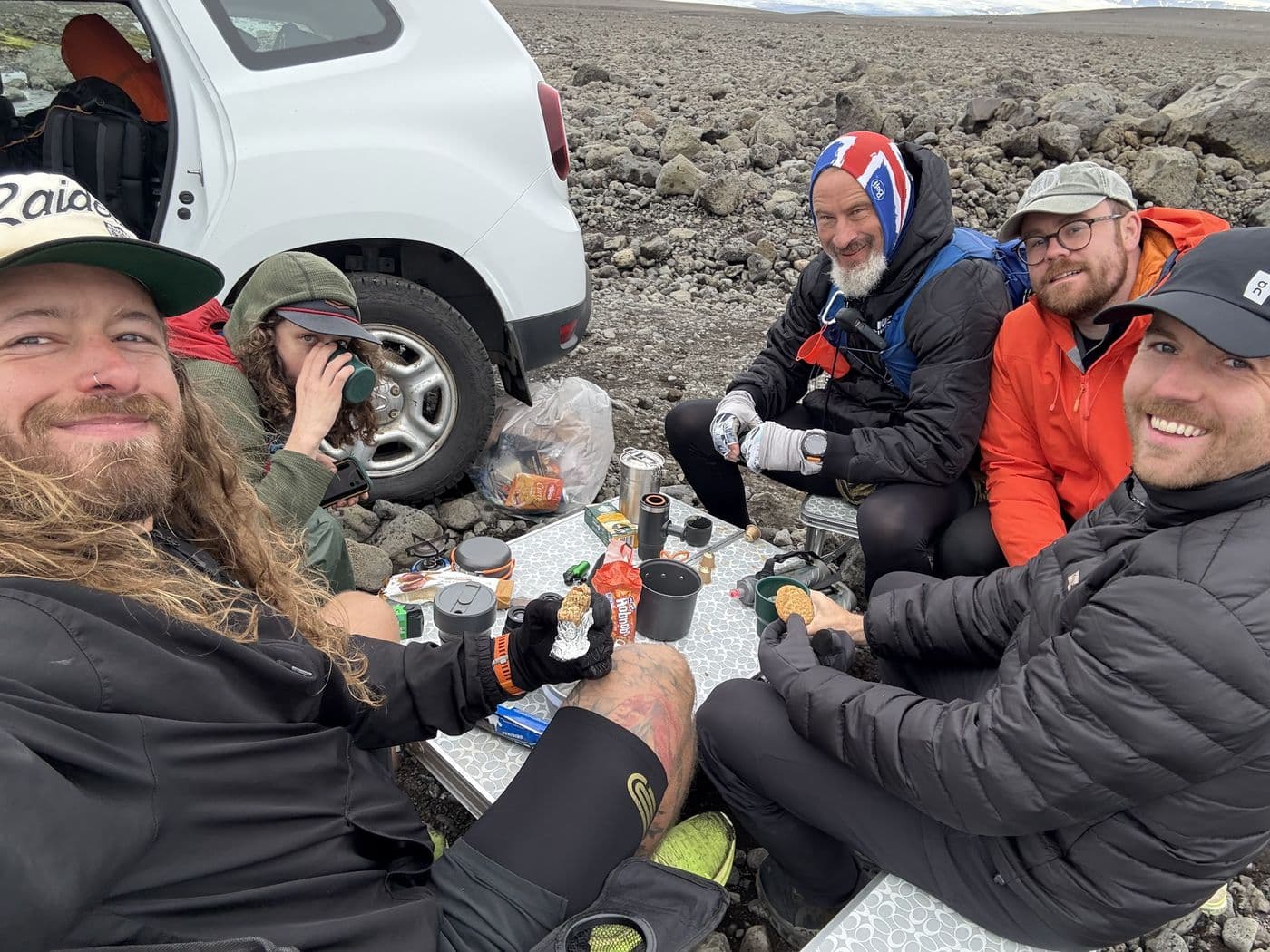 The crew sharing food at the support trucks