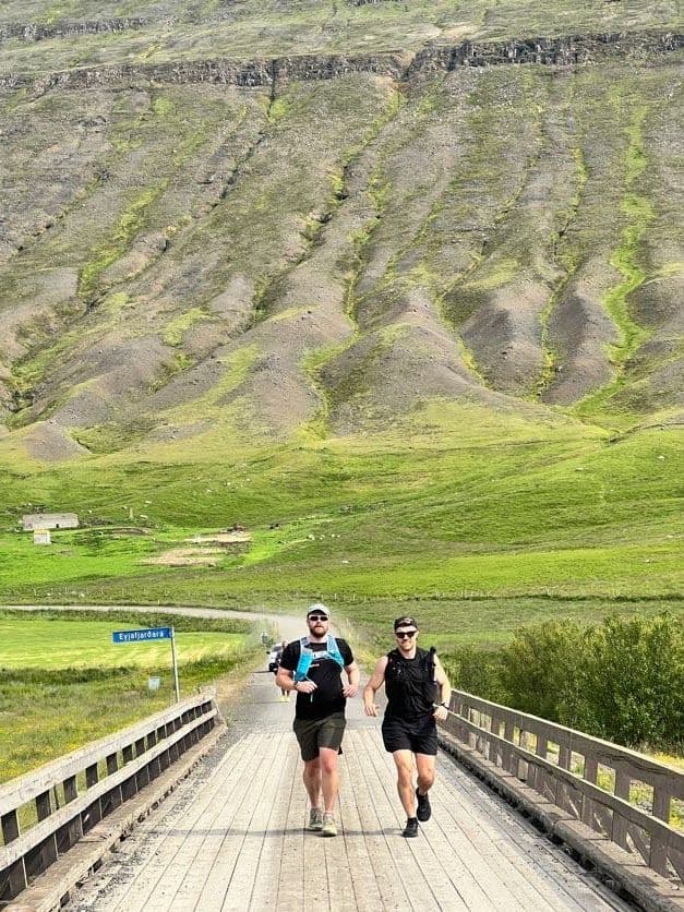 Runners crossing a wooden bridge