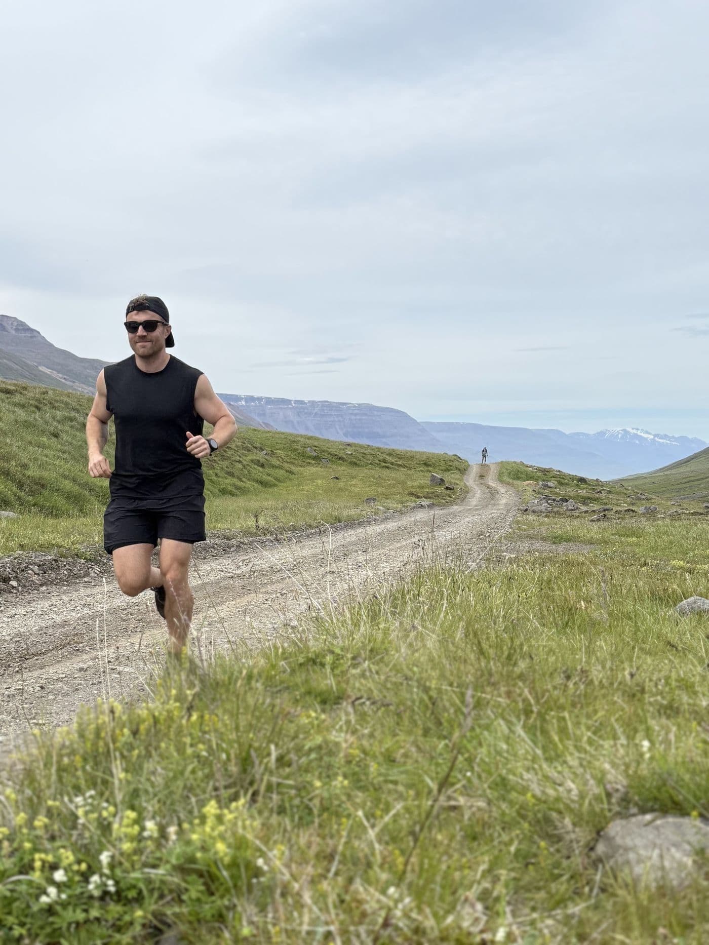 Justin True running toward you down a gravel road in the Icelandic highlands